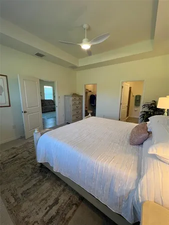 a bedroom with a bed and mirror