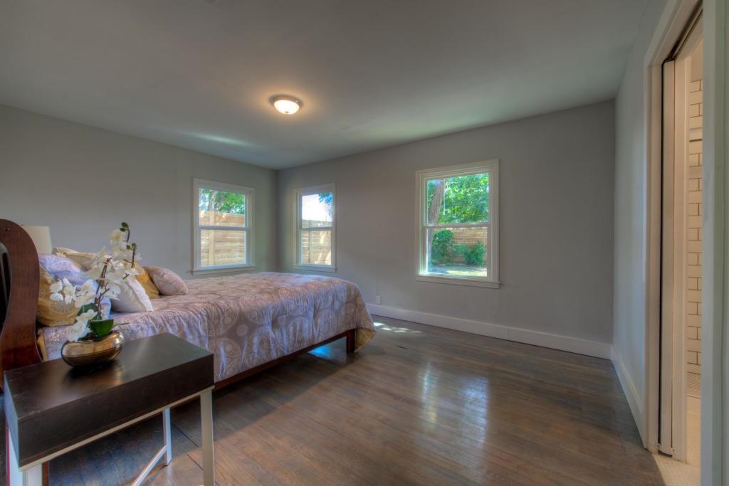 2011 Fort View Road Austin, TX 78704 - Photo 21 of 28 Polished hardwood floors and multiple windows anchor this serene bedroom retreat.