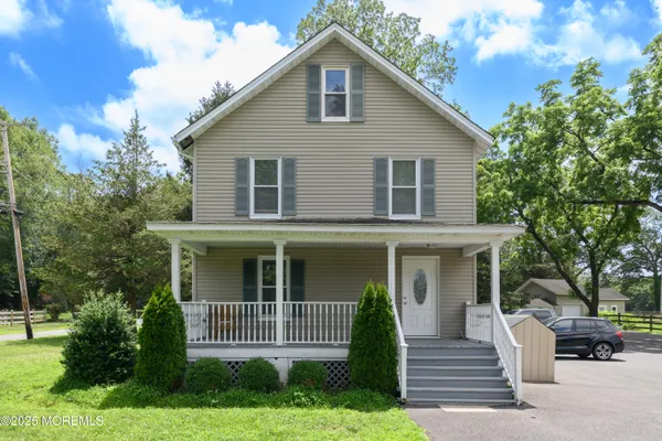 a front view of a house with a garden