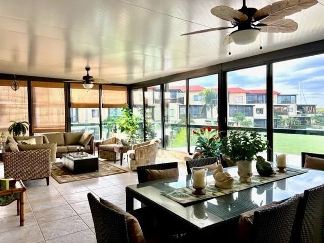 a view of a dining room with furniture large windows and wooden floor