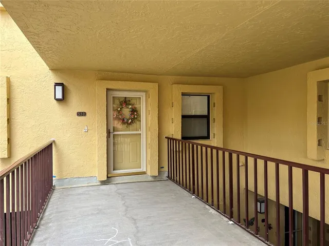 a view of a hallway with wooden floor and entryway