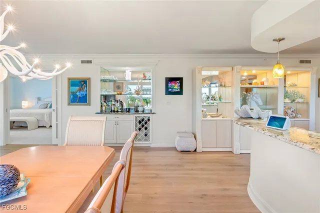 a room with kitchen island a large window and a couch