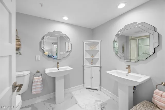 a bathroom with a sink a mirror and a toilet