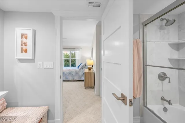 a bathroom with a tub shower and a sink