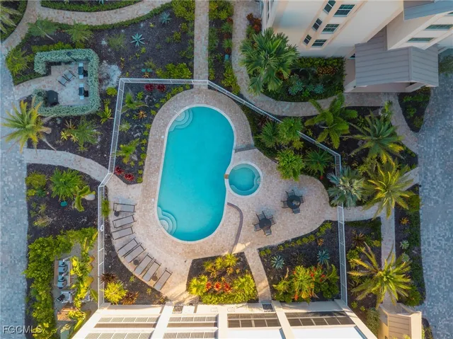 an aerial view of a swimming pool with a garden and plants
