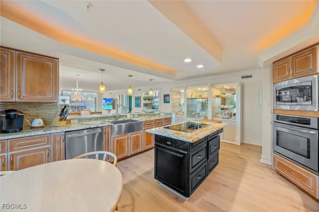 a kitchen with granite countertop a sink and counter top space