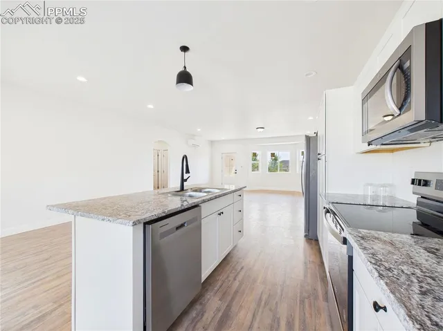 a kitchen with granite countertop a sink and stove