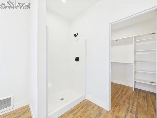 a view of a room with wooden floor