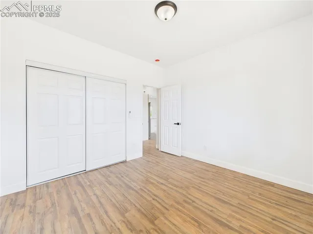 a view of a room with wooden floor