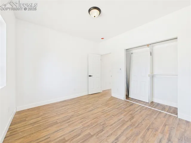 a view of room with wooden floor