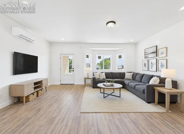 a living room with furniture and a flat screen tv