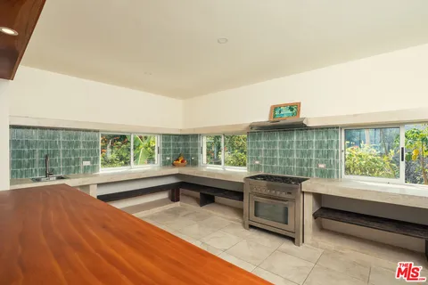 a kitchen with a sink and large window