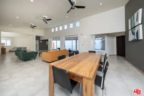 a room with table chairs and window