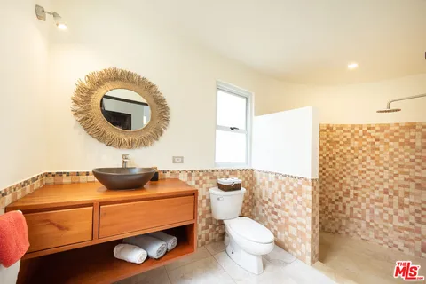 a spacious bedroom with a bed and glass door