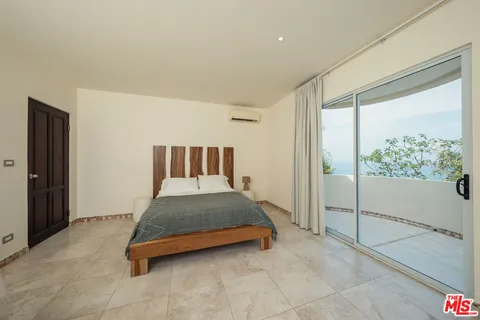 a view of backyard with tub and glass windows