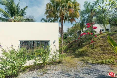a bedroom with a bed and a flat tv screen