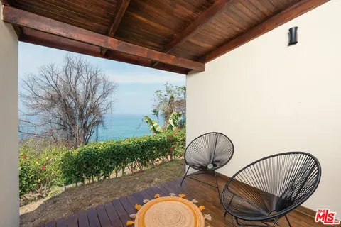 a view of a porch with furniture and a chair