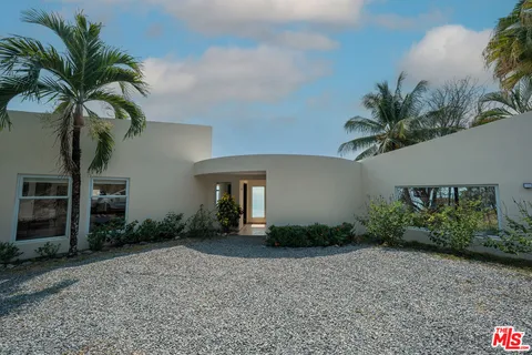 a view of a house with a yard and a garage