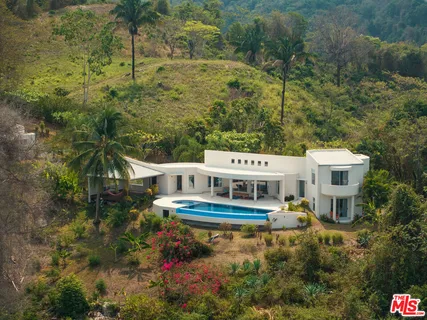 a living room with furniture and large windows