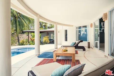 a view of a swimming pool and an outdoor seating