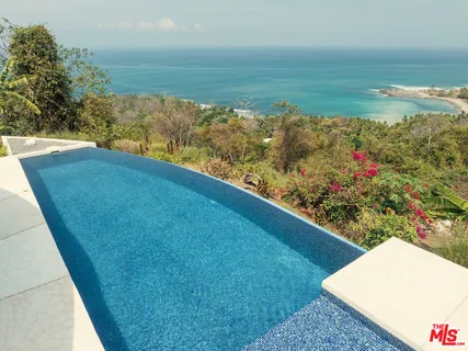 a view of a yard with an ocean view