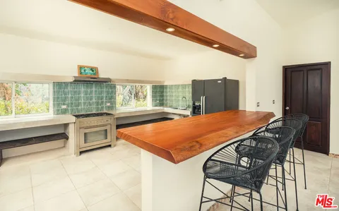 a room with pool table and windows