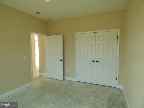 a view of a hallway with living room and chair
