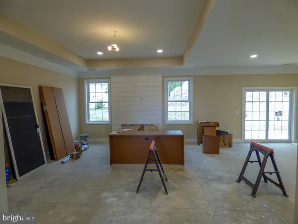 a room with table chairs and wooden floor
