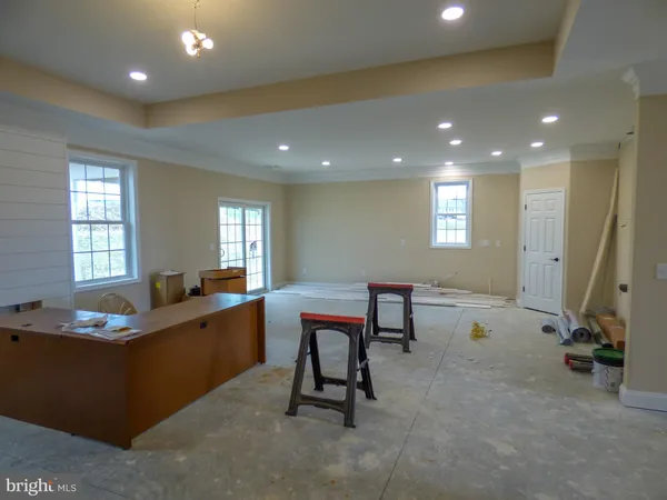 a room with a table chairs and wooden floor