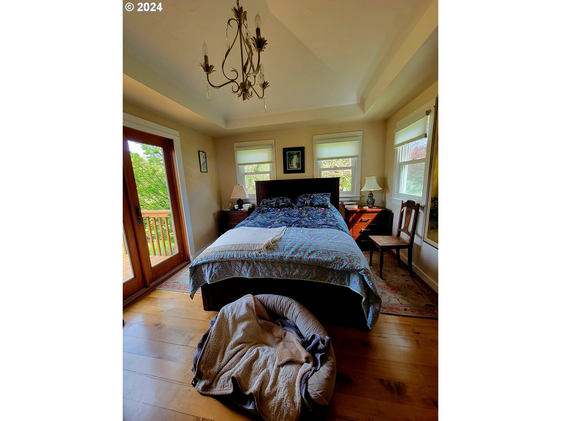 218 Hinkley Road Toledo, WA 98591 - Photo 6 of 31 a bedroom with a bed and a chandelier