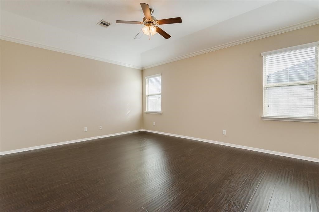 1903 Cadbury Castle Lane Fresno, TX 77545 - Photo 12 of 14 an empty room with wooden floor fan and windows