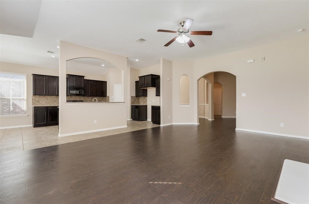 1903 Cadbury Castle Lane Fresno, TX 77545 - Photo 14 of 14 wooden floor in kitchen with a refrigerator and microwave