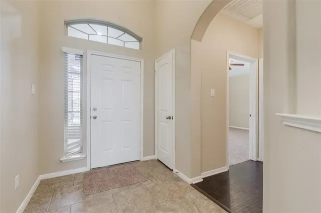 an empty room with wooden floor and closet