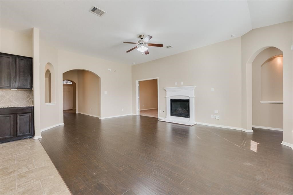 1903 Cadbury Castle Lane Fresno, TX 77545 - Photo 6 of 14 a view of an empty room with window and wooden floor