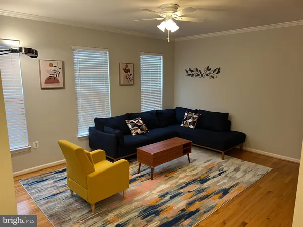 a living room with furniture and a mirror