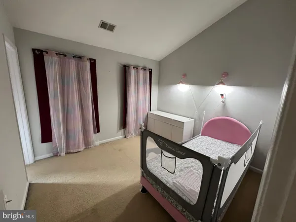 a view of a hallway with furniture and a window