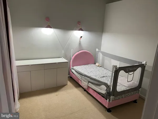a bedroom with a bed and a dresser