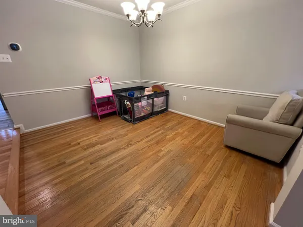 a view of a livingroom with furniture and wooden floor