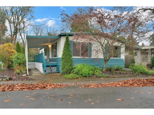 a front view of house with a garden