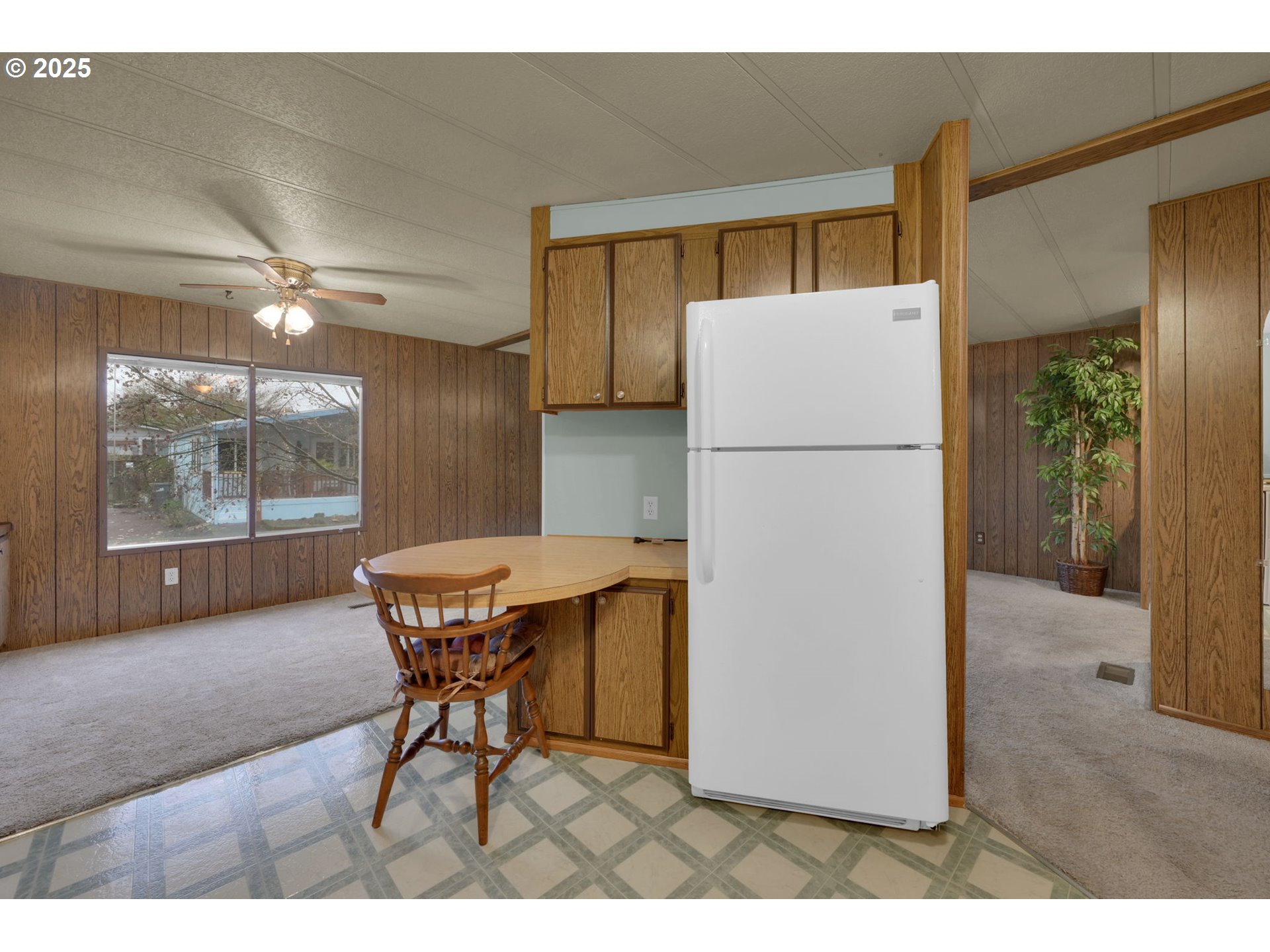 1475 Green Acres Road, Unit 13 Eugene, OR 97408 - Photo 15 of 39 a kitchen with a refrigerator and a table