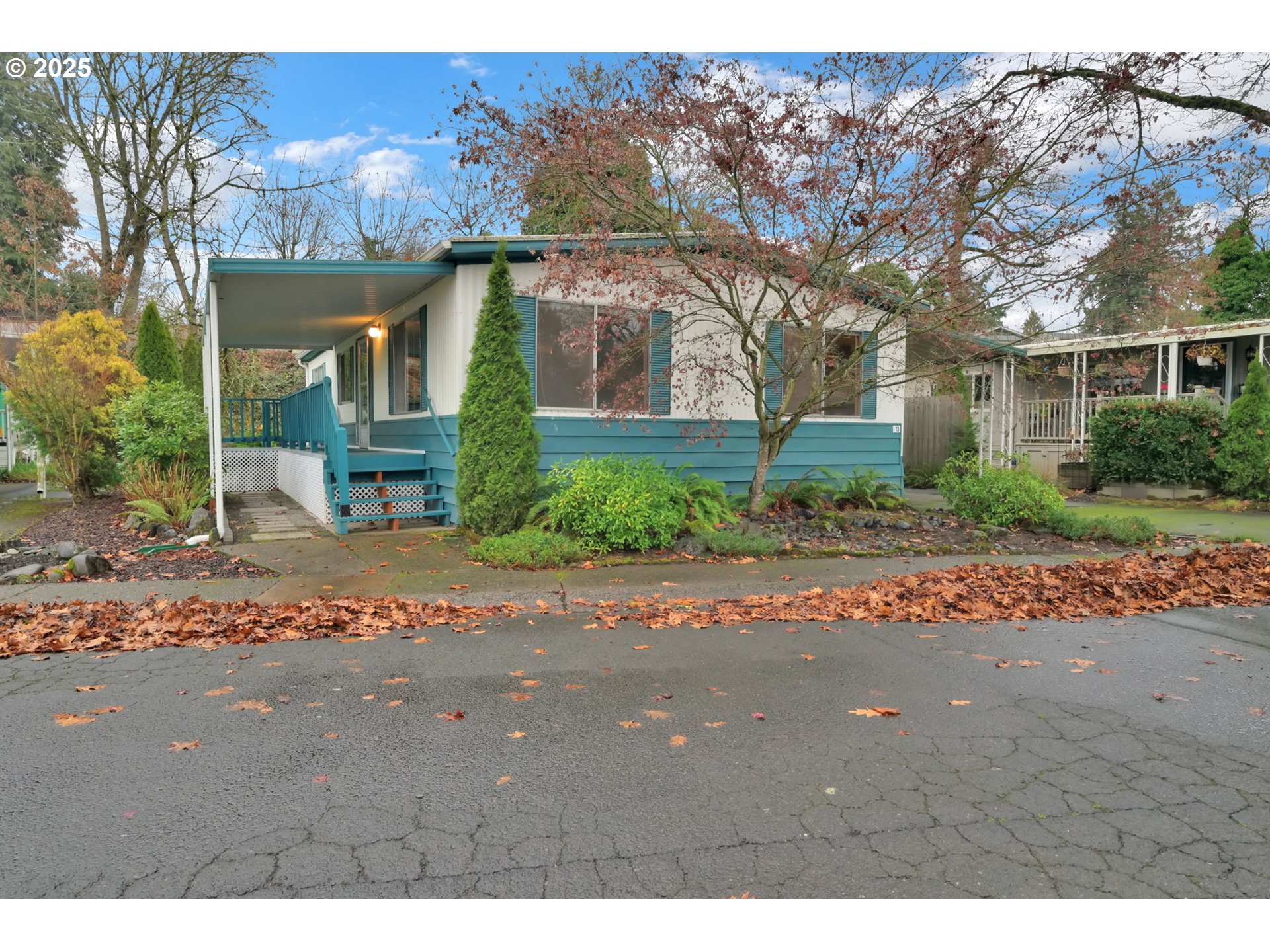 1475 Green Acres Road, Unit 13 Eugene, OR 97408 - Photo 39 of 39 a front view of a house with a yard and potted plants