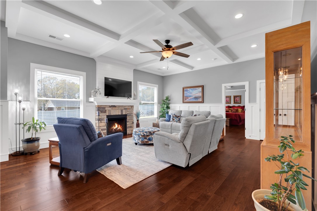 181 Amberwood Drive Anderson, SC 29621 - Photo 6 of 28 This living room features rich wood flooring, a cozy fireplace, and abundant natural light.