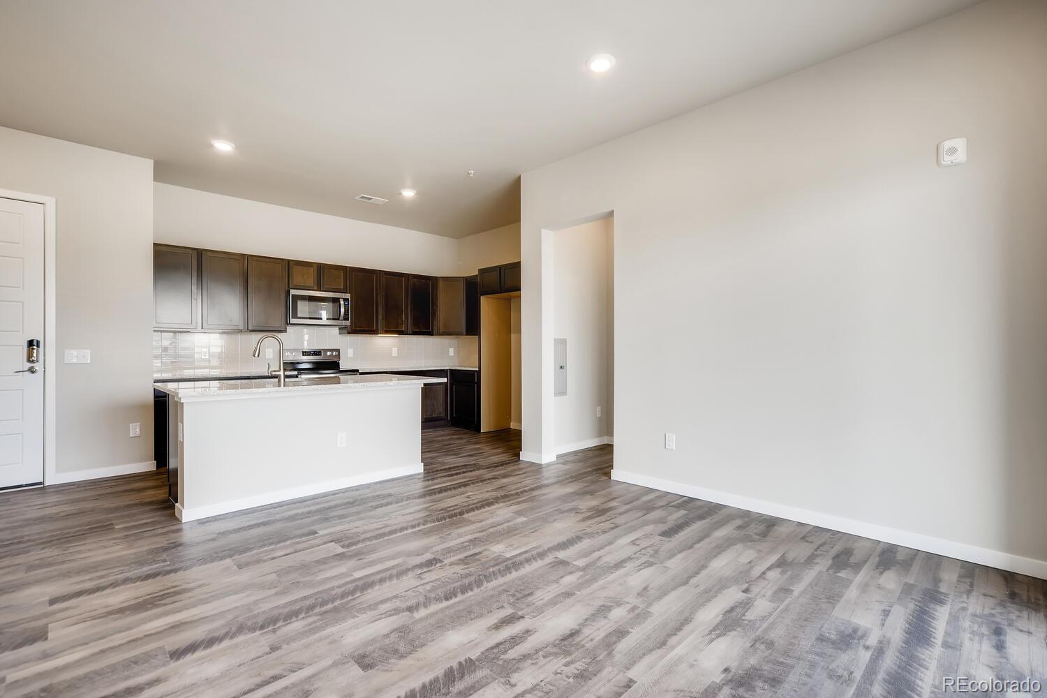 9283 Twenty Mile Road, Unit 406 Parker, CO 80134 - Photo 2 of 13 a view of kitchen with wooden floor