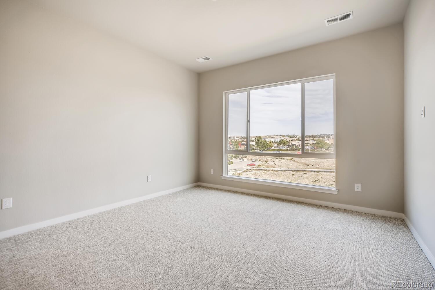 9283 Twenty Mile Road, Unit 406 Parker, CO 80134 - Photo 5 of 13 an empty room with a window