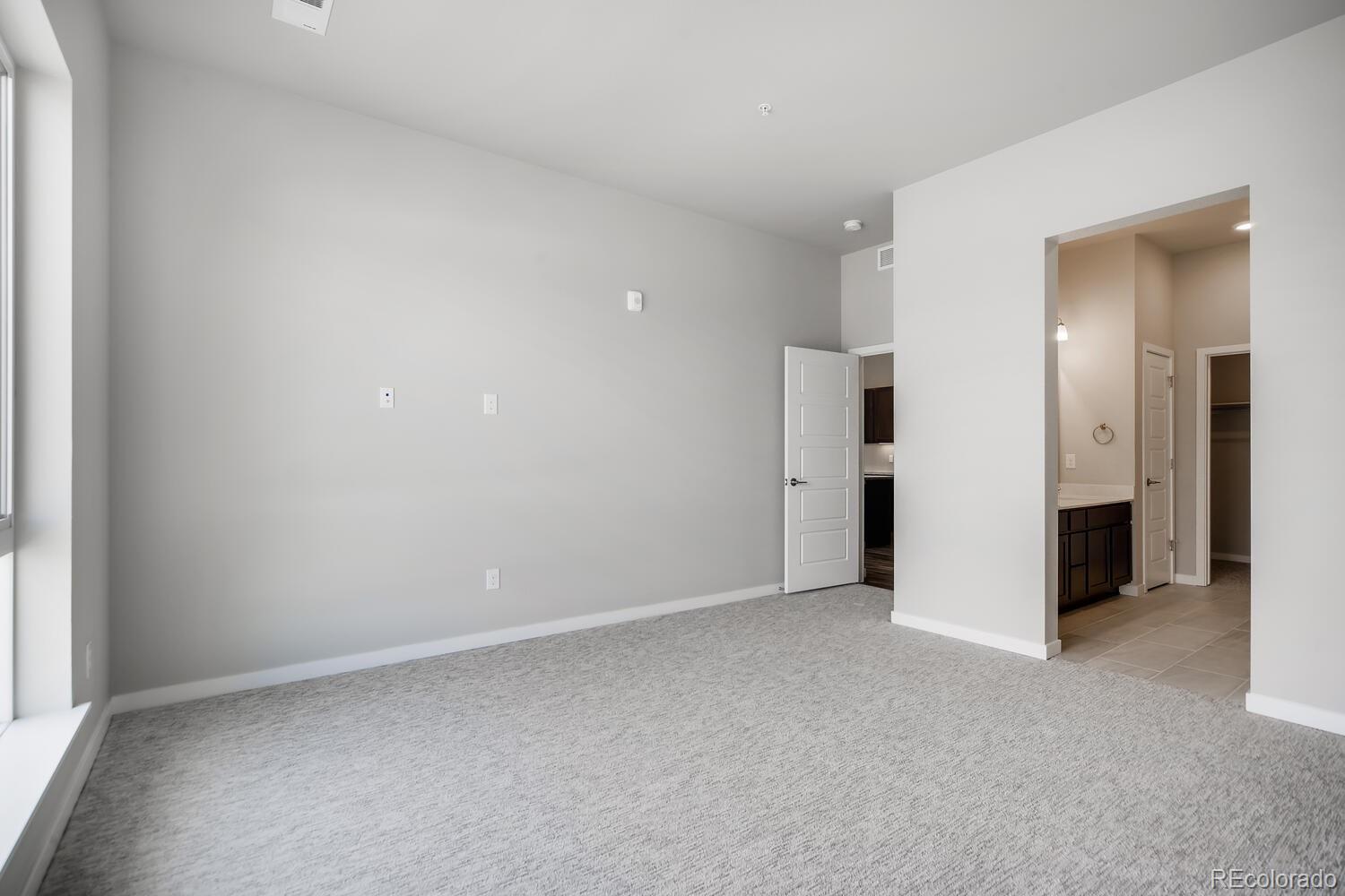 9283 Twenty Mile Road, Unit 406 Parker, CO 80134 - Photo 6 of 13 a view of an empty room with a window