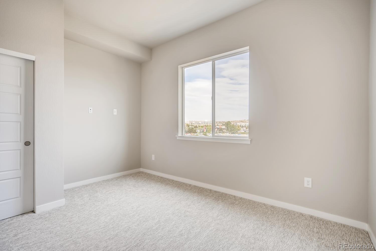 9283 Twenty Mile Road, Unit 406 Parker, CO 80134 - Photo 8 of 13 an empty room with a window