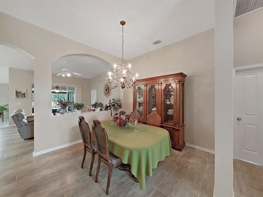 30612 Nickerson Loop Wesley Chapel, FL 33543 - Photo 11 of 47 a view of a dining room with furniture and chandelier