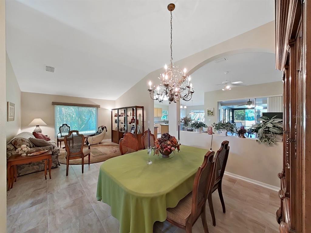 30612 Nickerson Loop Wesley Chapel, FL 33543 - Photo 12 of 47 a view of a dining room with furniture and chandelier