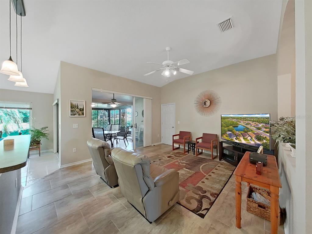30612 Nickerson Loop Wesley Chapel, FL 33543 - Photo 13 of 47 a living room with furniture and a flat screen tv