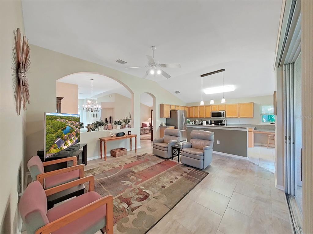 30612 Nickerson Loop Wesley Chapel, FL 33543 - Photo 15 of 47 a living room with fireplace furniture and a large window